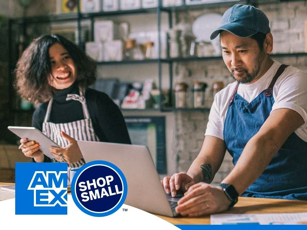 Shop owner working on Small Business Saturday - stock